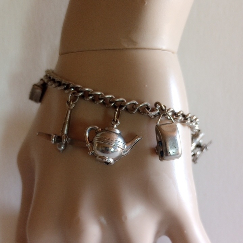 ELEGANT SILVER TONE METAL 8 CHARMS BRACELET 7" LONG. FUN TO WEAR.